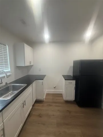 a kitchen that has a sink and a stove in it