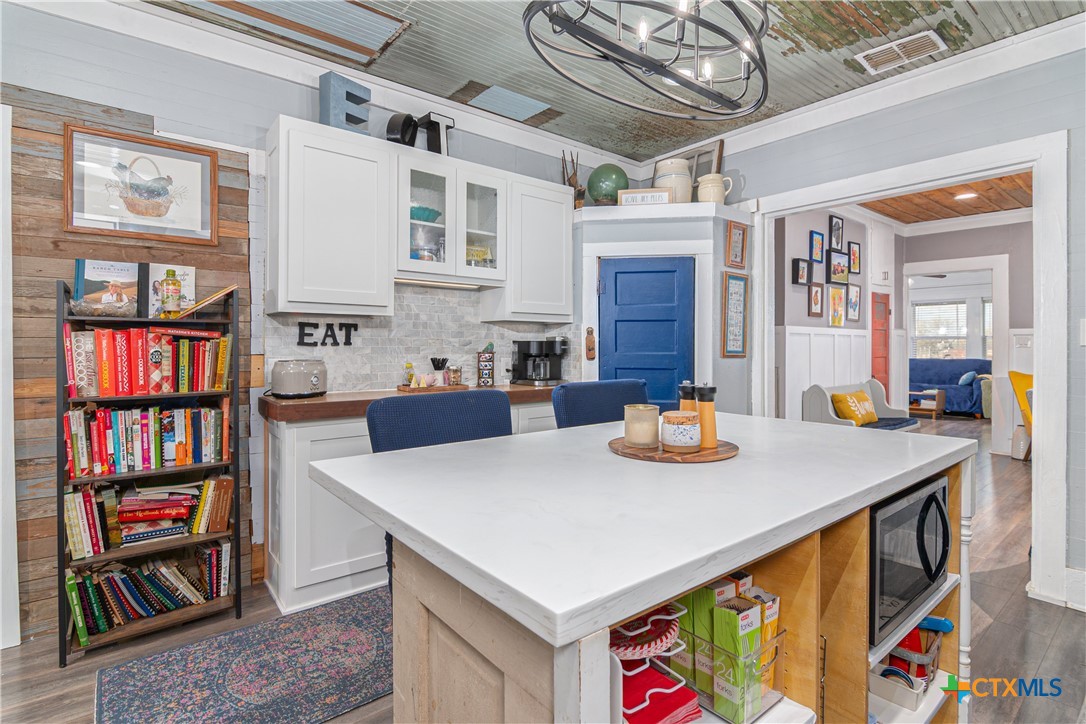 7150 Linne Road Seguin, TX 78155 - Photo 19 of 43 a view of kitchen island with cabinets and wooden floor