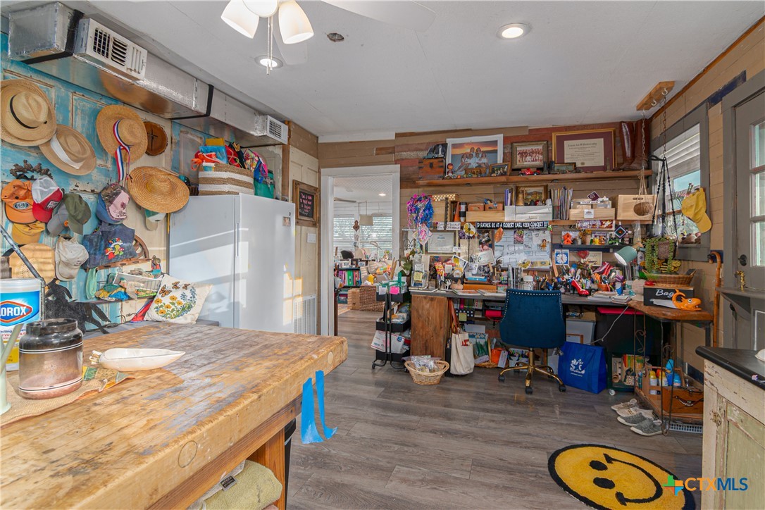 7150 Linne Road Seguin, TX 78155 - Photo 23 of 43 a room with stainless steel appliances kitchen island granite countertop furniture and a wooden floor