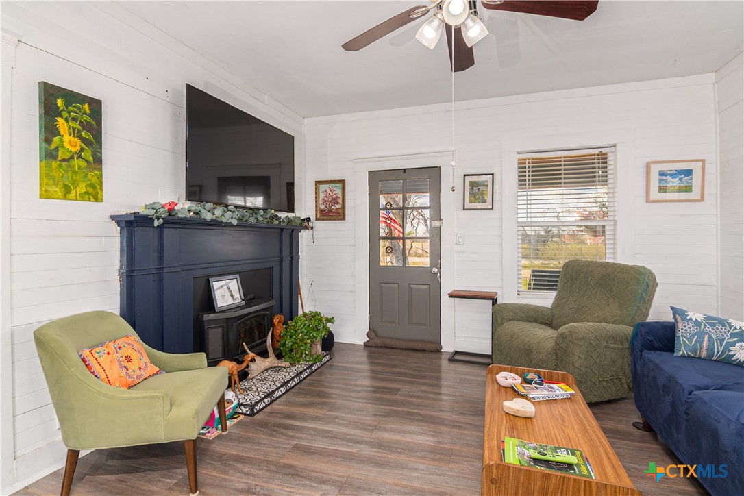 7150 Linne Road Seguin, TX 78155 - Photo 6 of 43 a living room with furniture a flat screen tv and a fireplace
