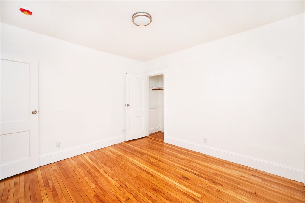 5 Chauncy Street, Unit 2 Cambridge, MA 02138 - Photo 11 of 16 a view of empty room with wooden floor