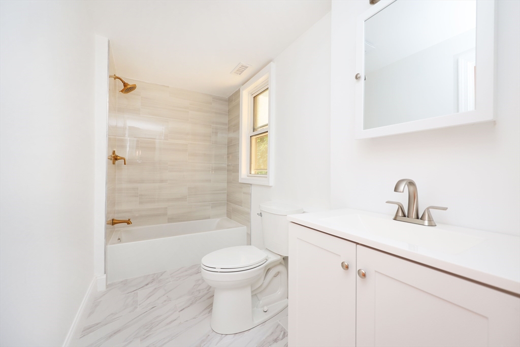 5 Chauncy Street, Unit 2 Cambridge, MA 02138 - Photo 6 of 16 a bathroom with a sink a toilet and shower
