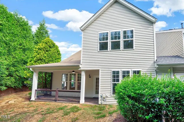 an empty room with chandelier fan