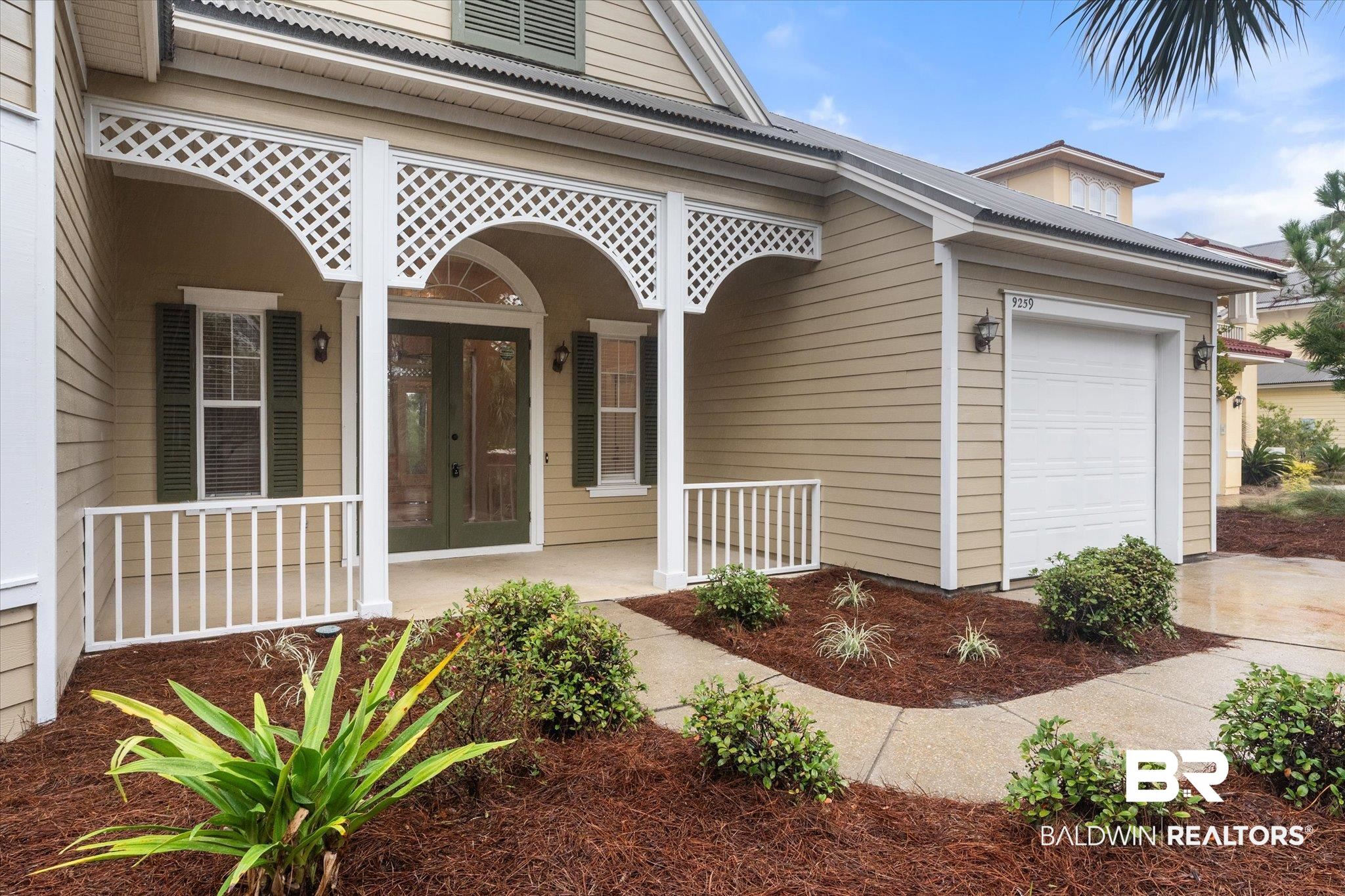 9259 Genipa Way Gulf Shores, AL 36542 - Photo 3 of 72 Doorway to property featuring a garage and a porch