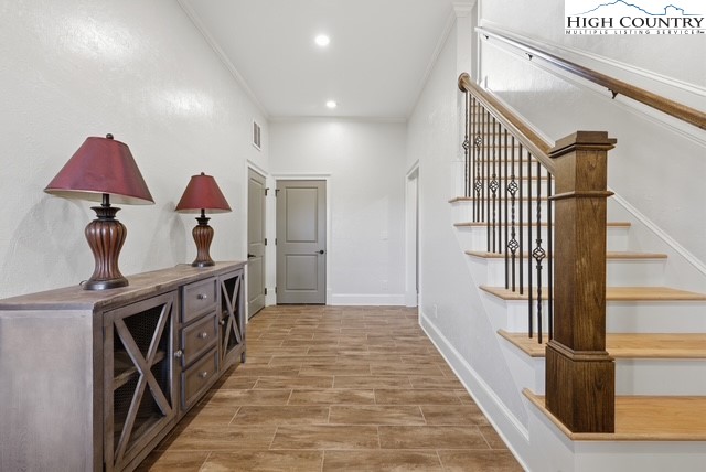 457 Autumn Leaf Way Crumpler, NC 28617 - Photo 32 of 37 a view of a hallway with wooden floor and staircase