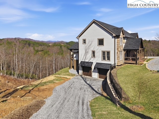 457 Autumn Leaf Way Crumpler, NC 28617 - Photo 36 of 37 a view of a house with backyard and sitting area