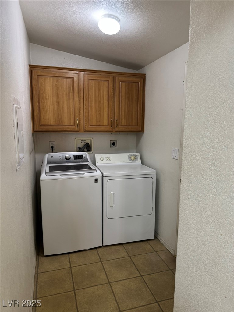 237 Piute Lane Henderson, NV 89015 - Photo 4 of 7 Washroom featuring cabinet space, independent washer and dryer, light tile patterned floors, and a textured ceiling
