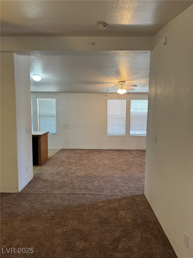 237 Piute Lane Henderson, NV 89015 - Photo 6 of 7 Spare room featuring carpet, a textured ceiling, ceiling fan, plenty of natural light, and a smoke detector