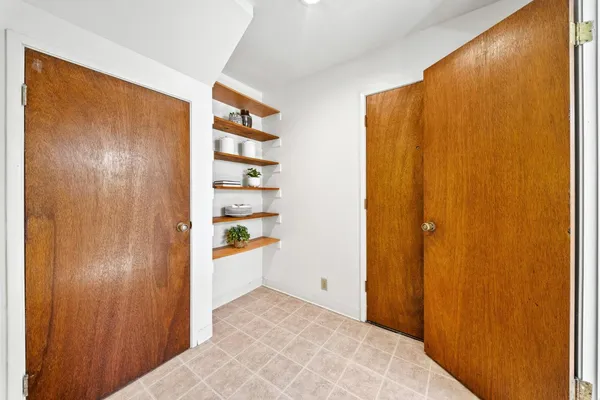 a view of a kitchen with a refrigerator and a sink