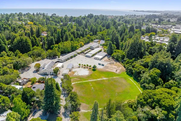 an aerial view of a house with a yard