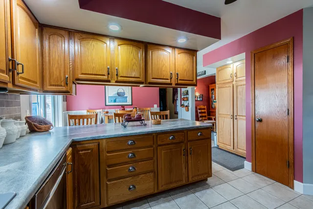 a kitchen with stainless steel appliances granite countertop a refrigerator and a stove