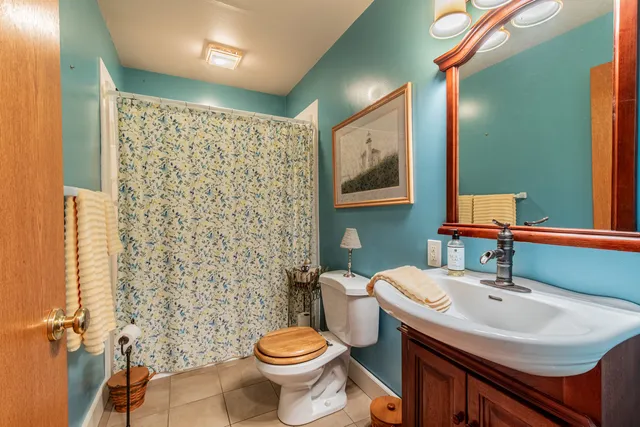 a bathroom with a sink toilet and mirror