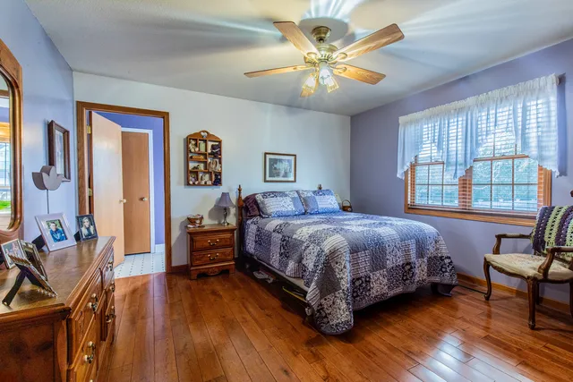 a spacious bedroom with a bed and a chandelier