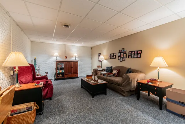 a living room with furniture and a lamp