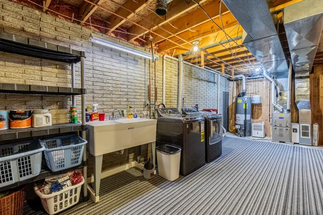 a utility room with stainless steel appliances and cabinets
