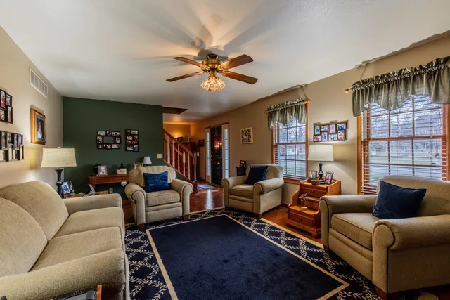 a living room with furniture ceiling fan and a rug