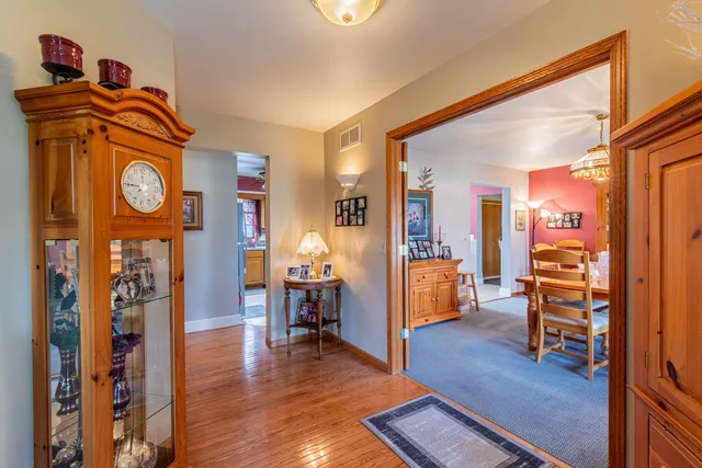 a view of an entryway with furniture and wooden floor