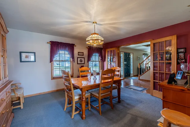 a dining room with furniture window and wooden floor