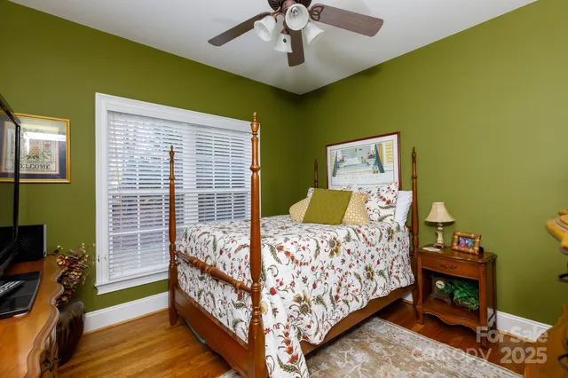 a bed sitting in a bedroom next to a window