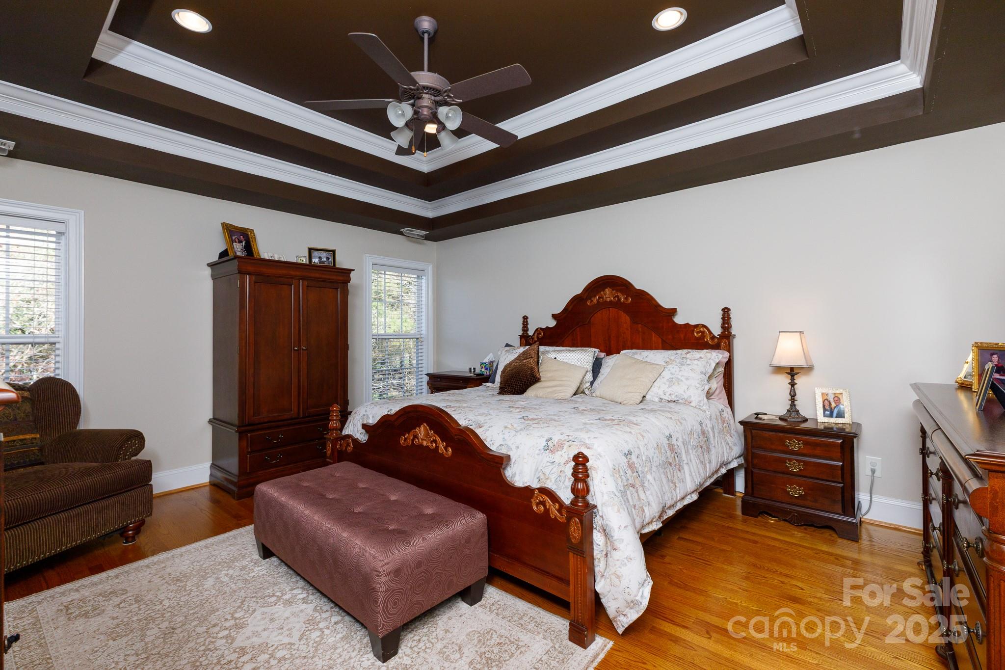 307 Abingdon Way Fort Mill, SC 29715 - Photo 15 of 26 a spacious bedroom with a bed a couch and a chandelier