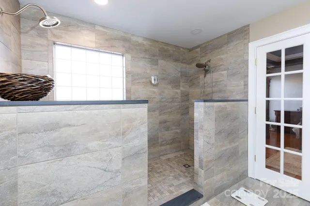 a bathroom with a bathtub and a shower