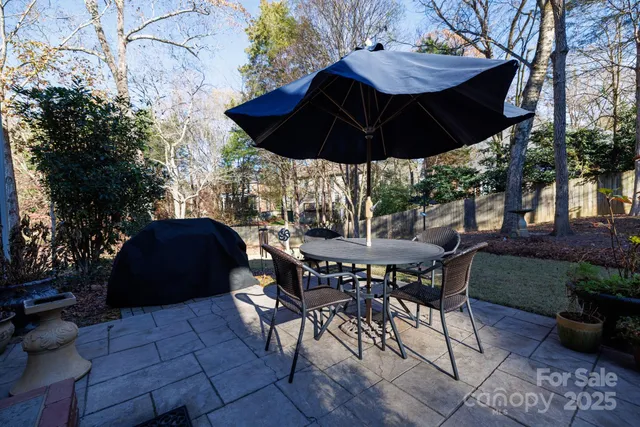 a view of an outdoor sitting area with furniture and umbrella