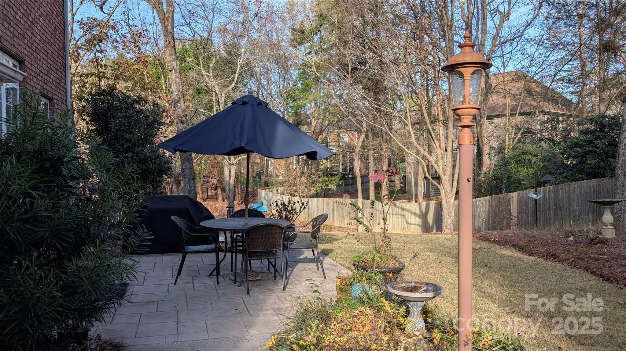 307 Abingdon Way Fort Mill, SC 29715 - Photo 25 of 26 a view of a patio with furniture and table under an umbrella