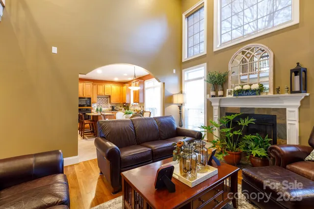 a living room with furniture a fireplace and a wall painting