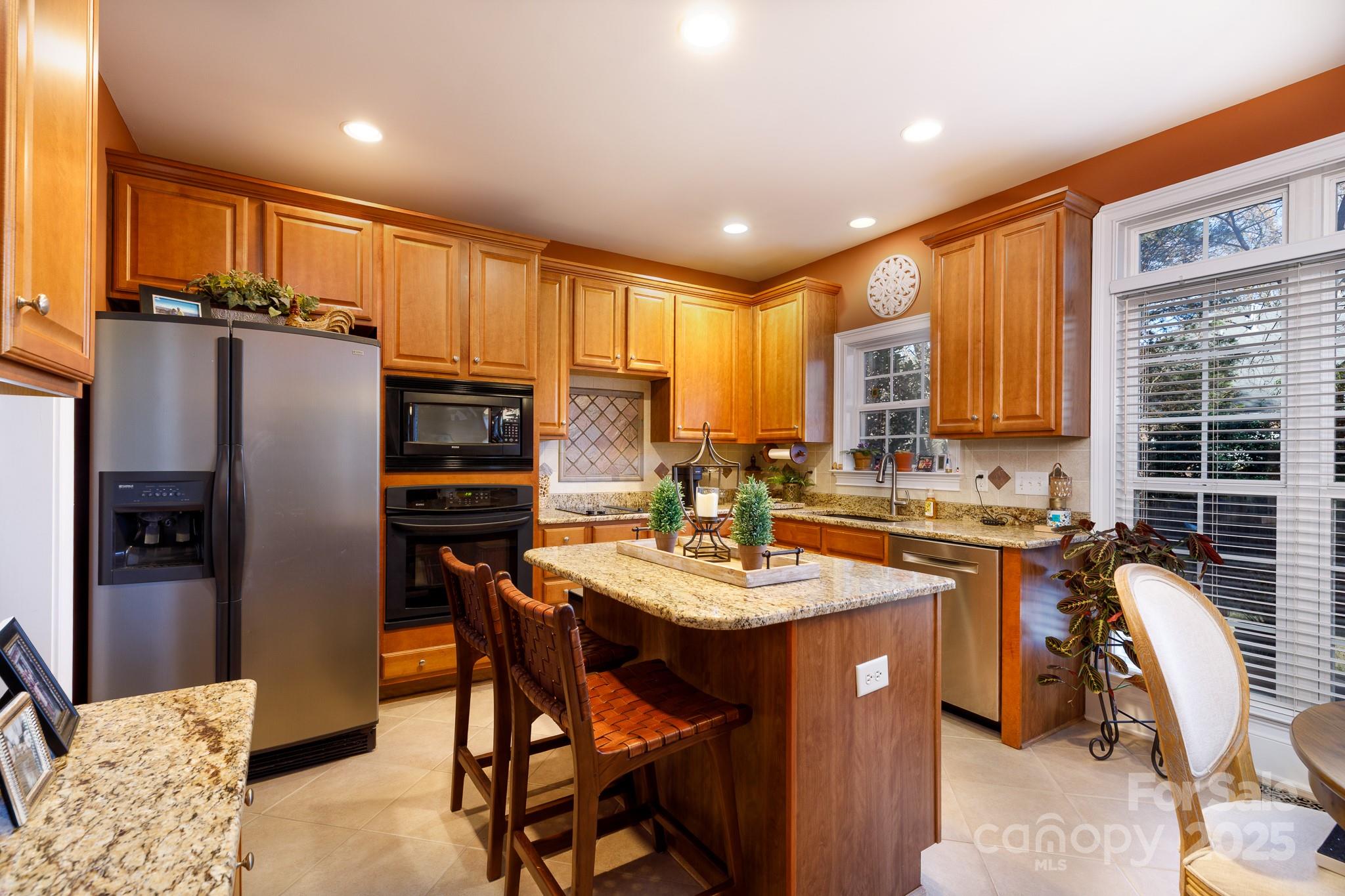 307 Abingdon Way Fort Mill, SC 29715 - Photo 8 of 26 a kitchen with a sink refrigerator and cabinets