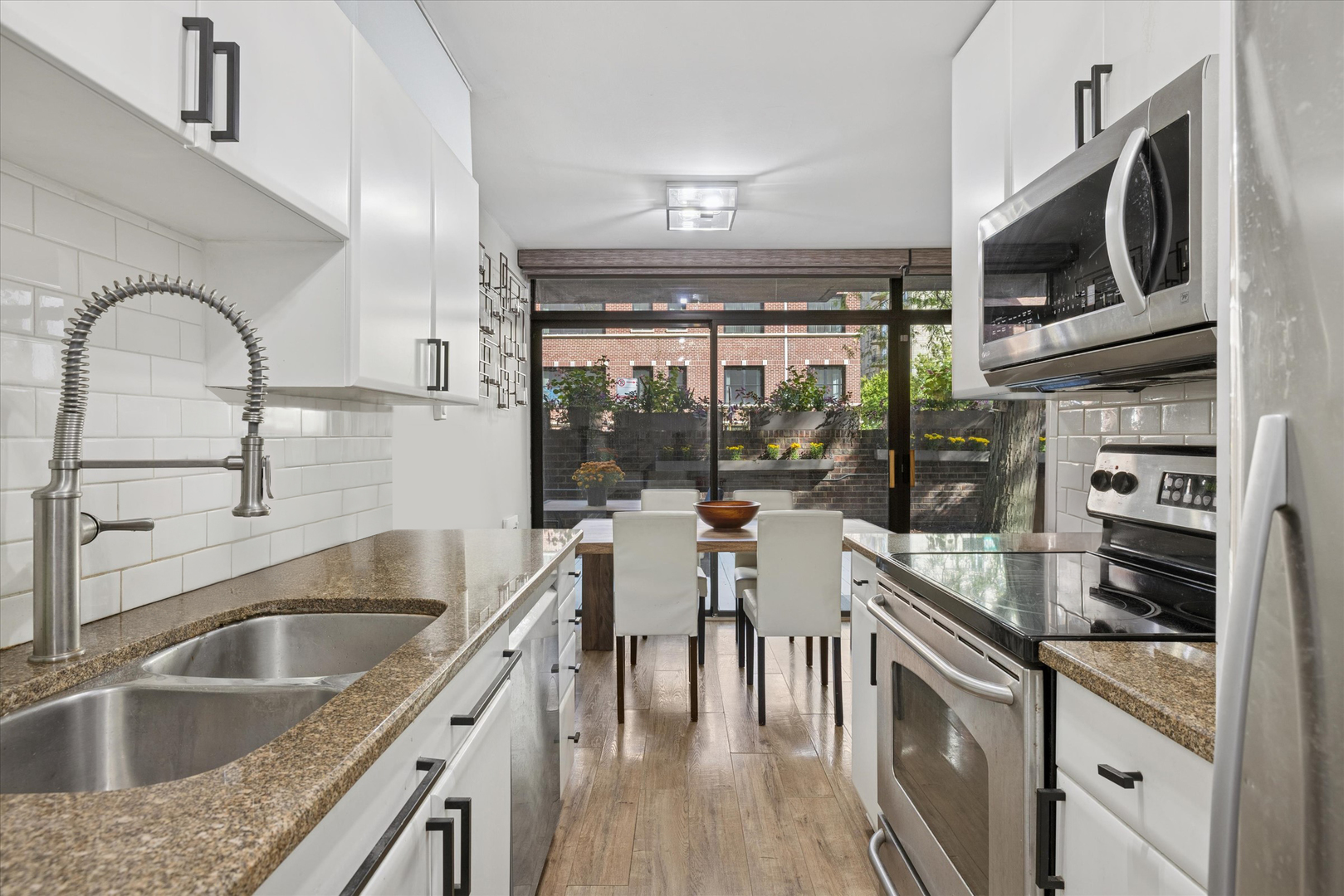 2600 North Hampden Court, Unit J1 Chicago, IL 60614 - Photo 7 of 16 a kitchen with a sink a counter top space and stainless steel appliances