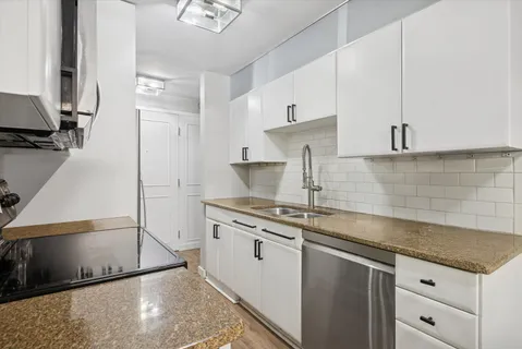 a kitchen with stainless steel appliances granite countertop a sink stove and refrigerator