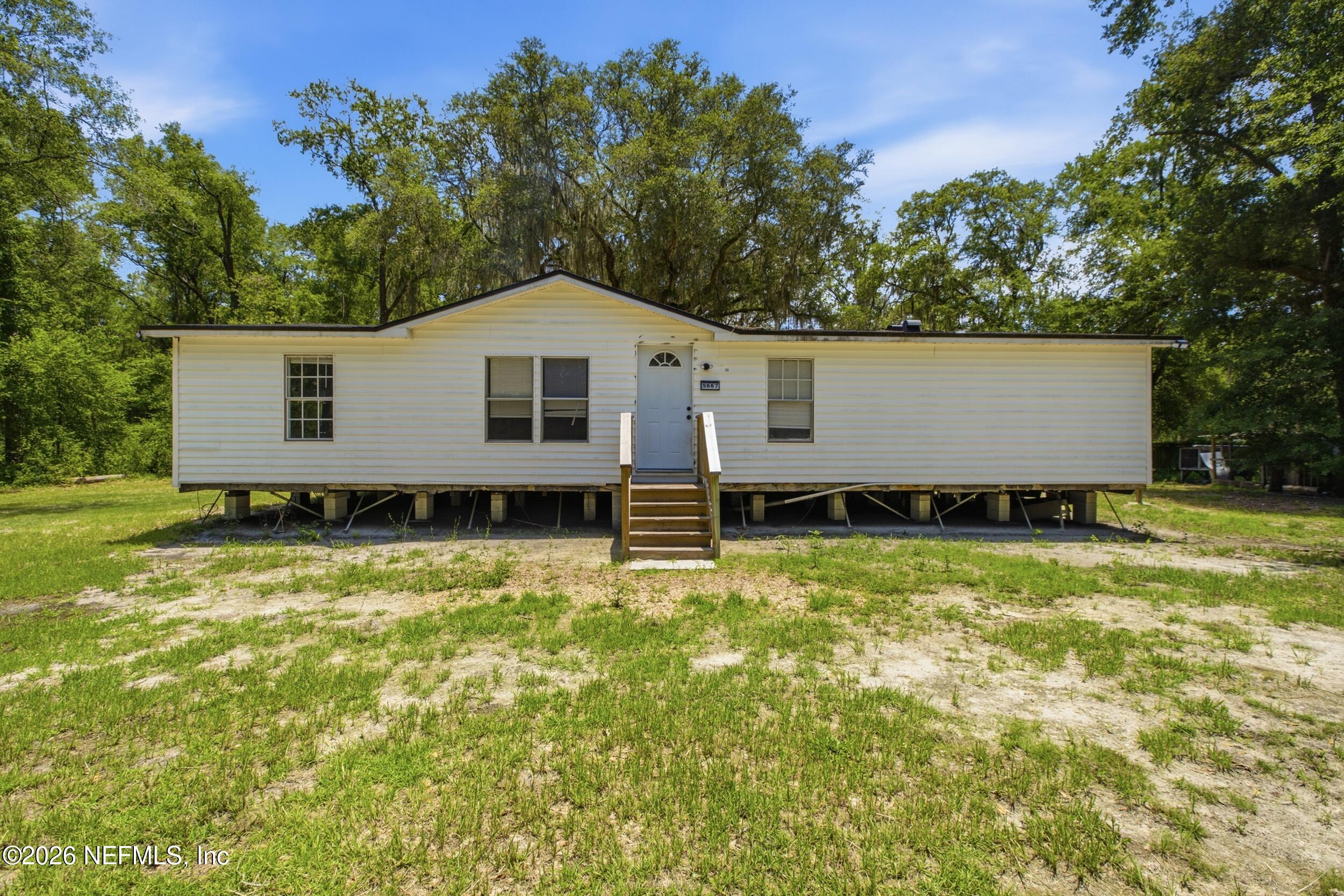 5667 Long Branch Cemetery Road Jacksonville, FL 32234 - Photo 1 of 24 a house view with a garden space