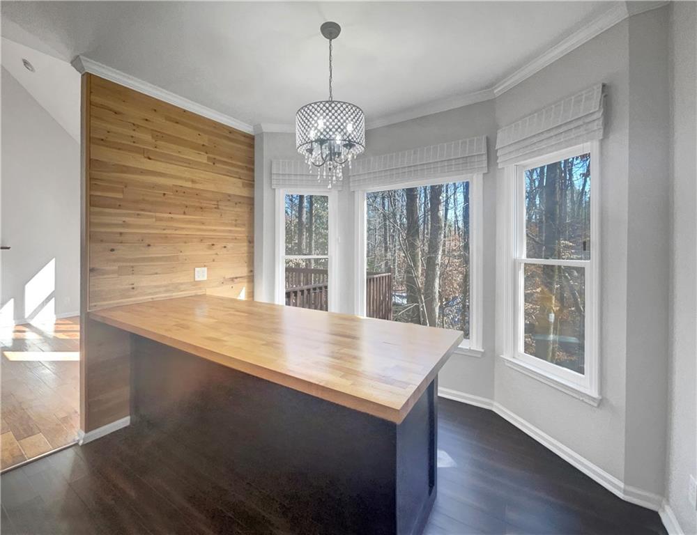 3950 Bear Ridge Place Northwest Kennesaw, GA 30144 - Photo 11 of 41 a view of a room with wooden floor chandelier and windows