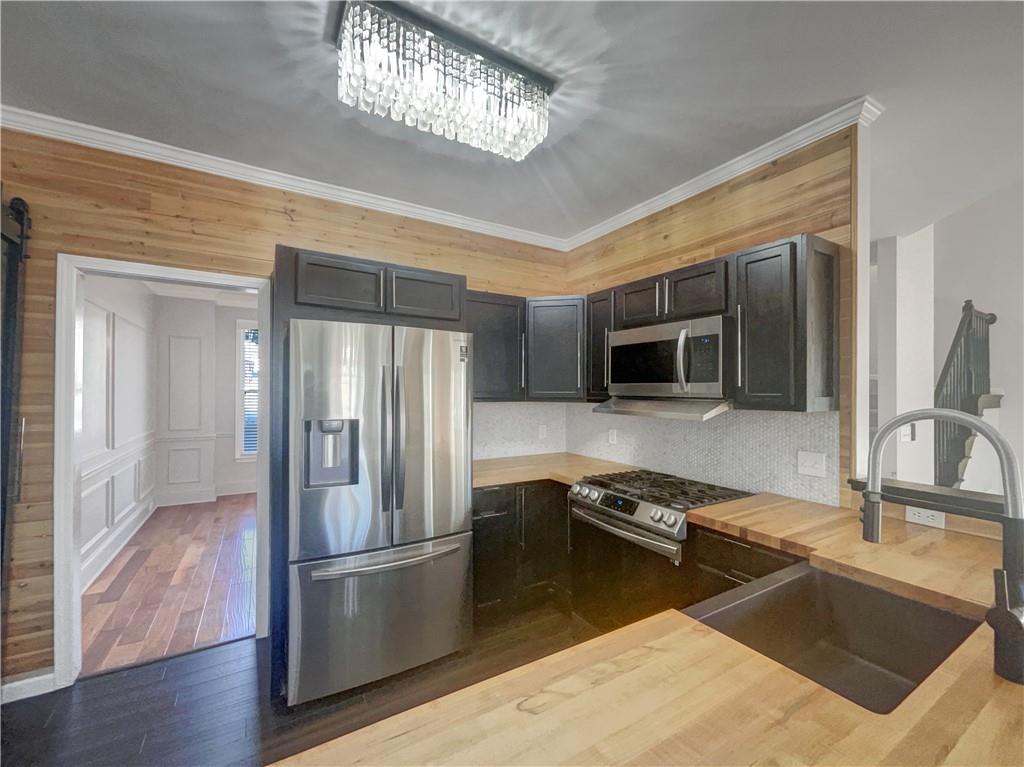 3950 Bear Ridge Place Northwest Kennesaw, GA 30144 - Photo 13 of 41 a kitchen with a sink stainless steel appliances and chandelier