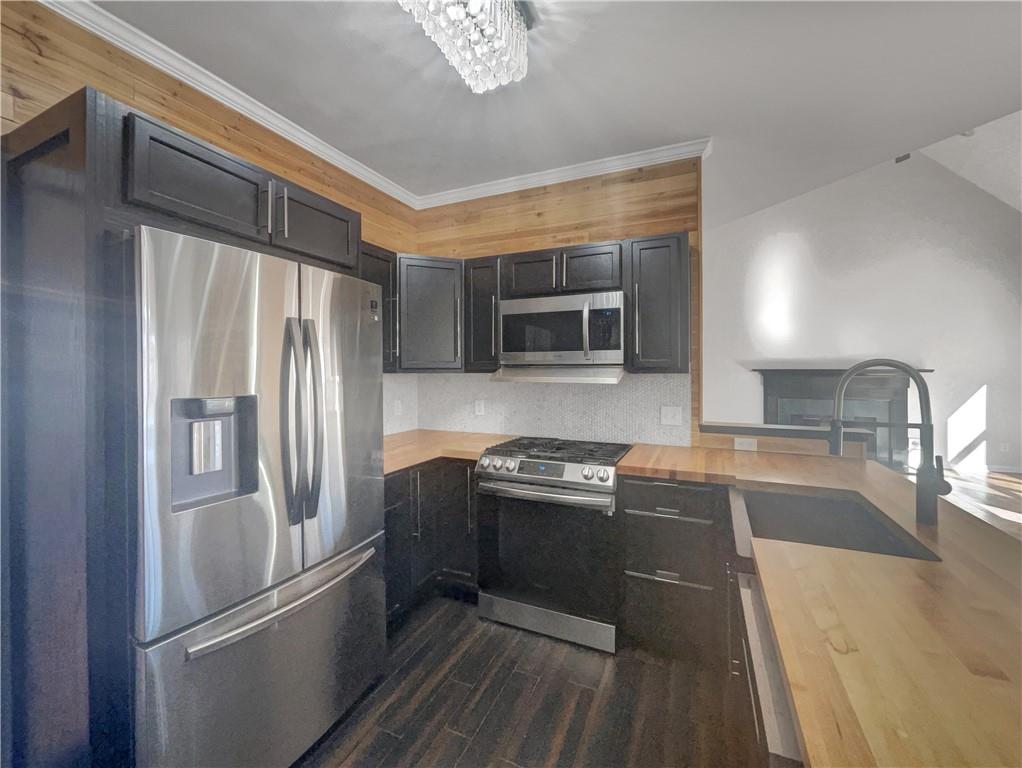 3950 Bear Ridge Place Northwest Kennesaw, GA 30144 - Photo 14 of 41 a kitchen with stainless steel appliances granite countertop a refrigerator a stove and a sink with wooden floor