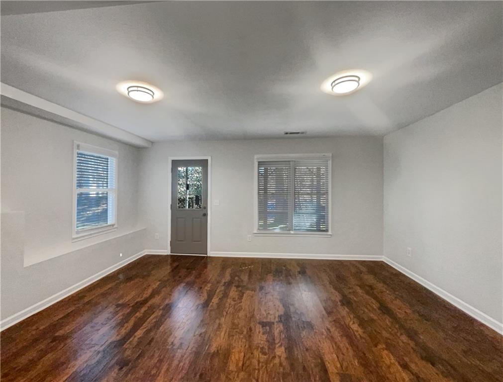3950 Bear Ridge Place Northwest Kennesaw, GA 30144 - Photo 17 of 41 a view of an empty room with wooden floor and a window