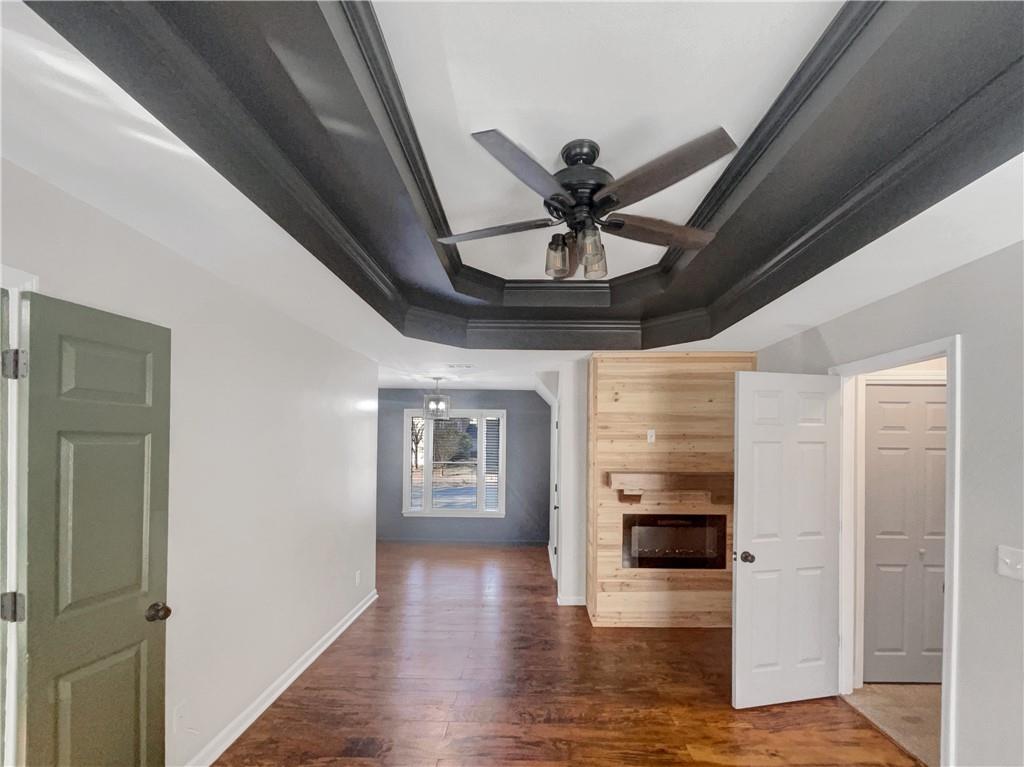 3950 Bear Ridge Place Northwest Kennesaw, GA 30144 - Photo 19 of 41 a view of a hallway with wooden floor and a kitchen
