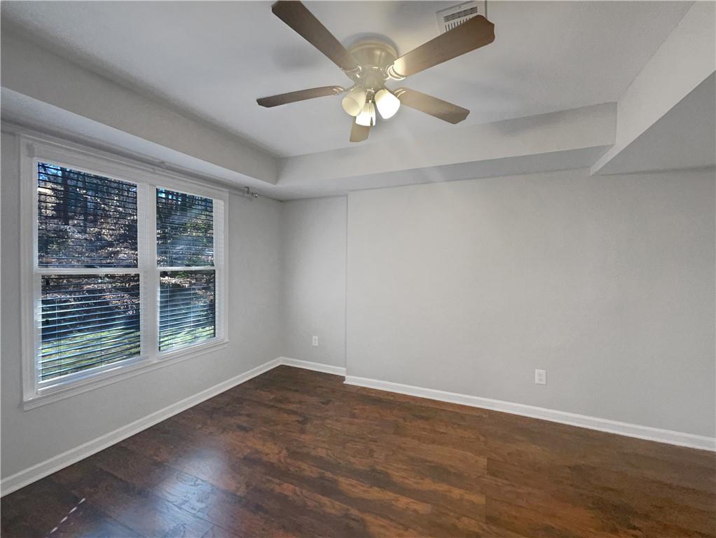 3950 Bear Ridge Place Northwest Kennesaw, GA 30144 - Photo 21 of 41 a view of an empty room with wooden floor and a window