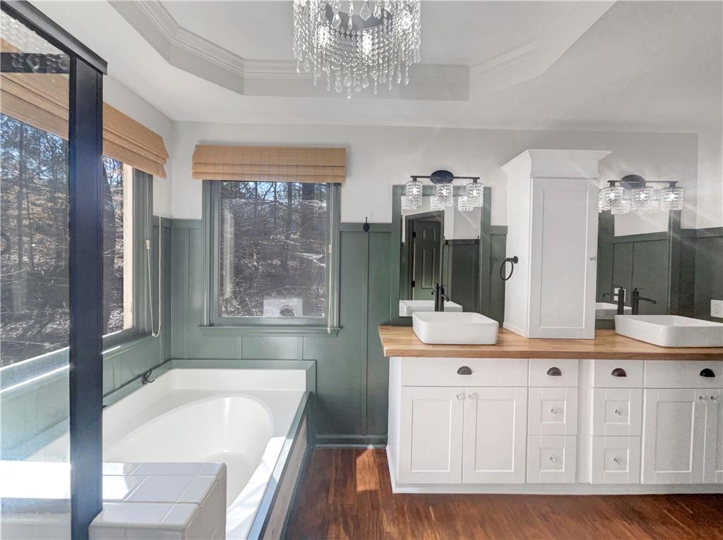 3950 Bear Ridge Place Northwest Kennesaw, GA 30144 - Photo 30 of 41 a bathroom with a tub a double vanity sink a mirror and a shower