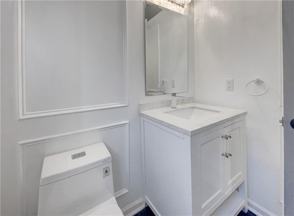 3950 Bear Ridge Place Northwest Kennesaw, GA 30144 - Photo 37 of 41 a bathroom with a sink a toilet and a mirror