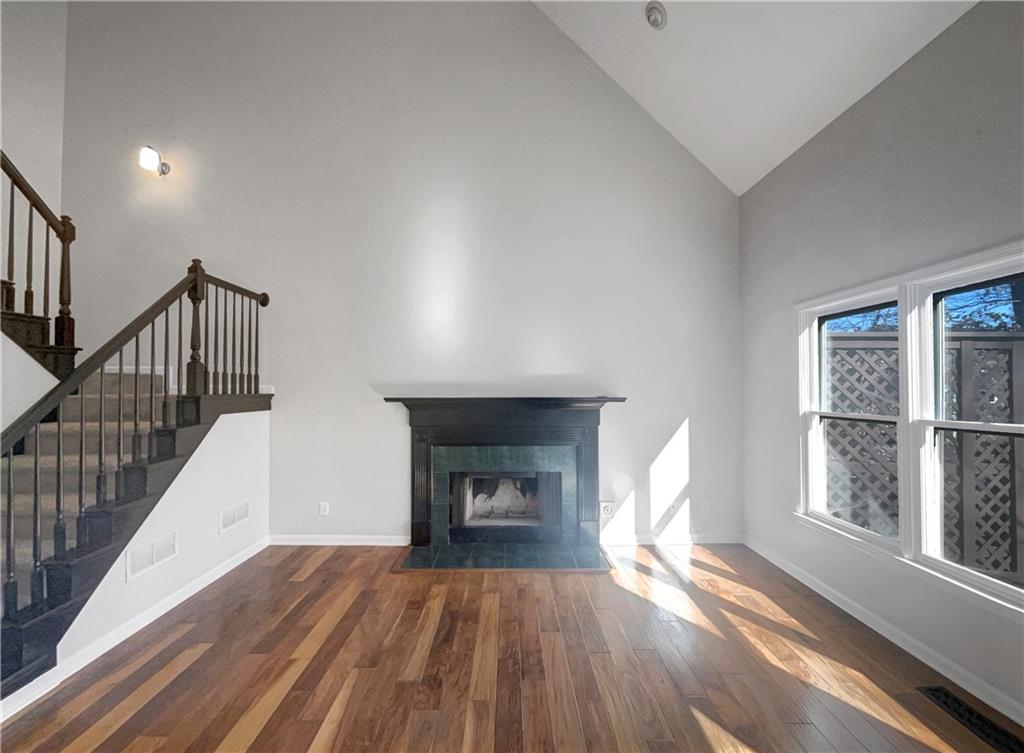 3950 Bear Ridge Place Northwest Kennesaw, GA 30144 - Photo 6 of 41 a view of empty room with wooden floor and fireplace