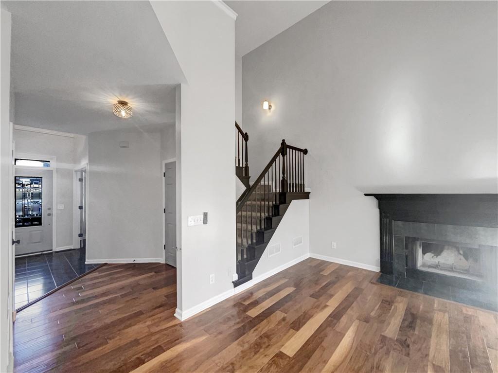 3950 Bear Ridge Place Northwest Kennesaw, GA 30144 - Photo 7 of 41 a view of empty room with wooden floor and fireplace