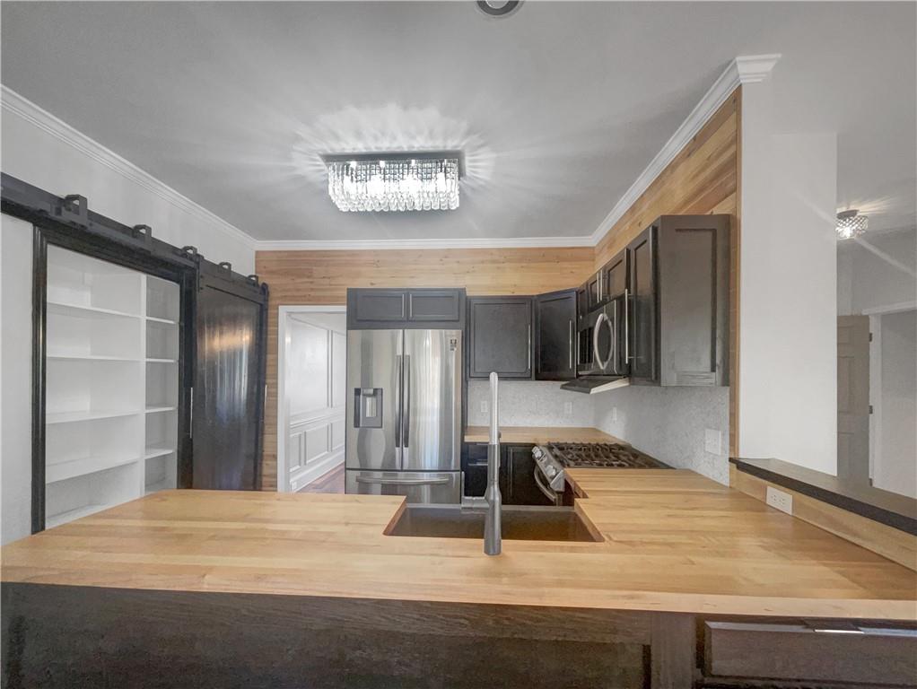 3950 Bear Ridge Place Northwest Kennesaw, GA 30144 - Photo 8 of 41 a view of a kitchen with a sink and a refrigerator