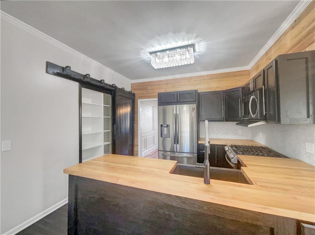 3950 Bear Ridge Place Northwest Kennesaw, GA 30144 - Photo 9 of 41 a room with kitchen island a sink and wooden floor