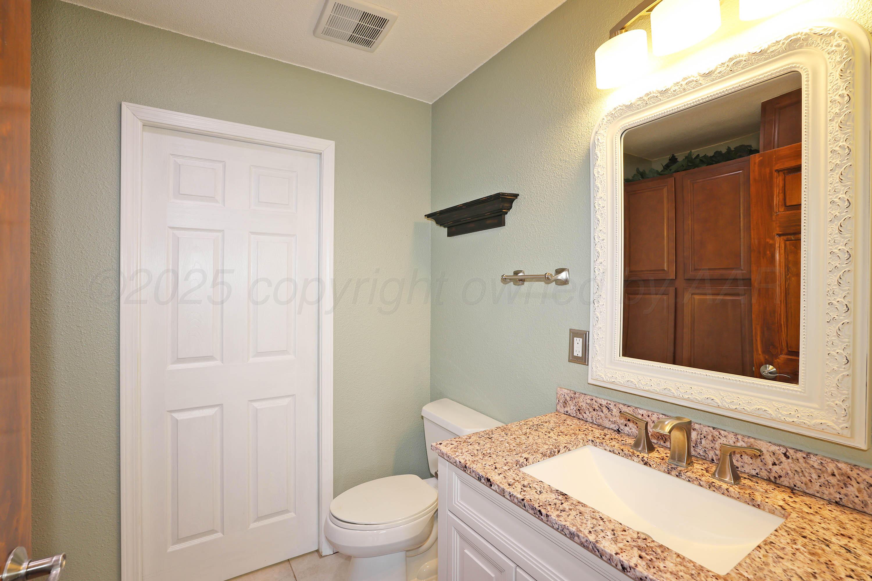 7722 Canode Drive Amarillo, TX 79121 - Photo 14 of 40 a bathroom with a granite countertop sink toilet and shower