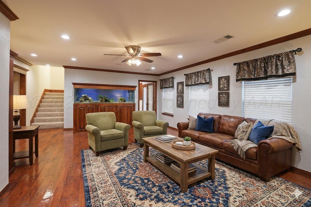 7722 Canode Drive Amarillo, TX 79121 - Photo 16 of 40 a living room with furniture ceiling fan and a rug