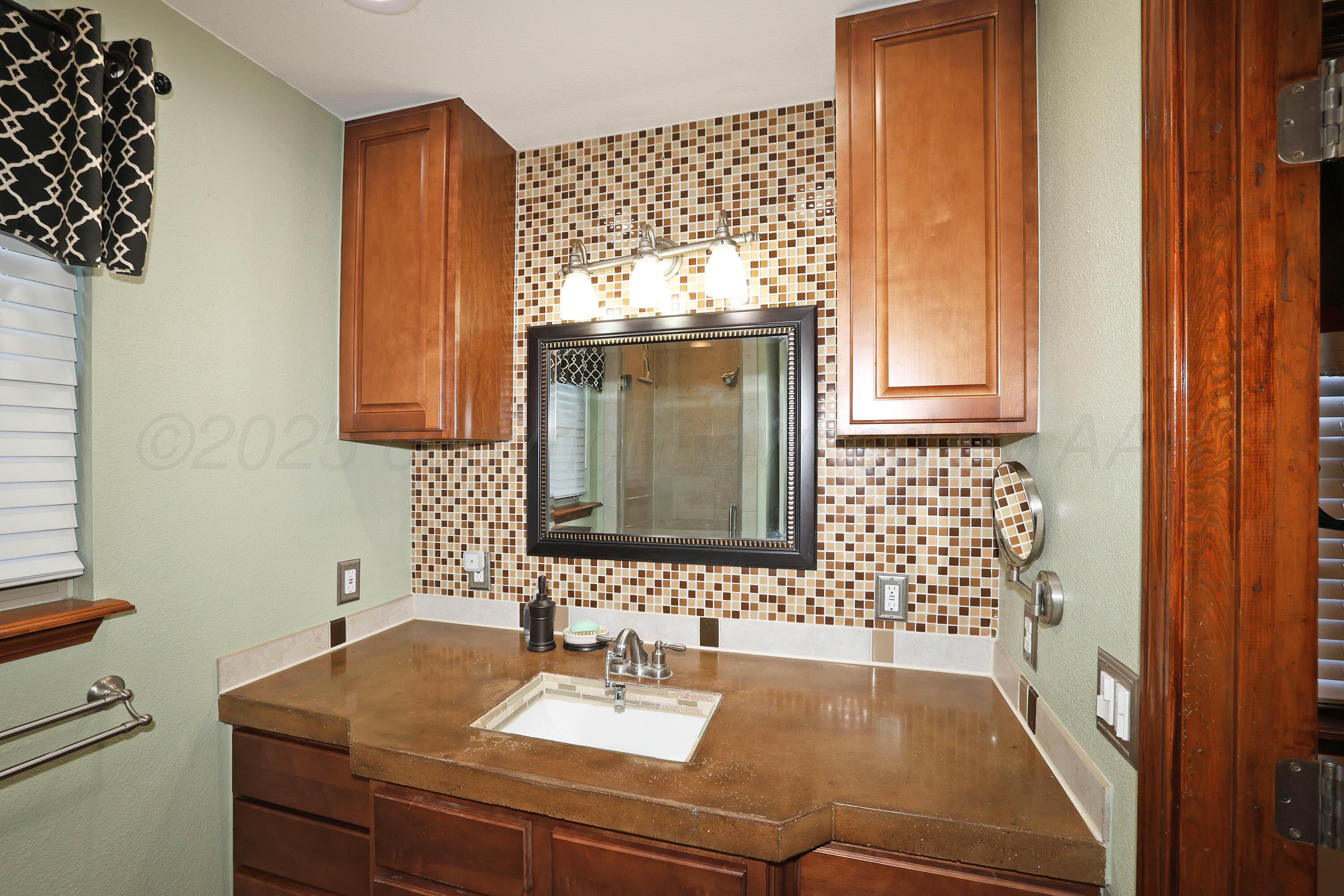7722 Canode Drive Amarillo, TX 79121 - Photo 20 of 40 a bathroom with a sink and a mirror