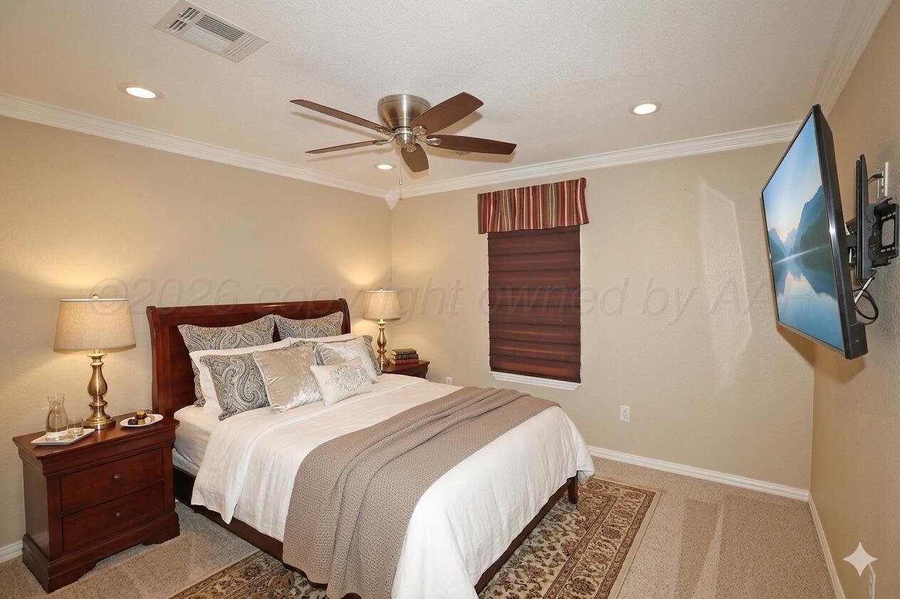 7722 Canode Drive Amarillo, TX 79121 - Photo 23 of 40 a bedroom with a bed and a flat screen tv