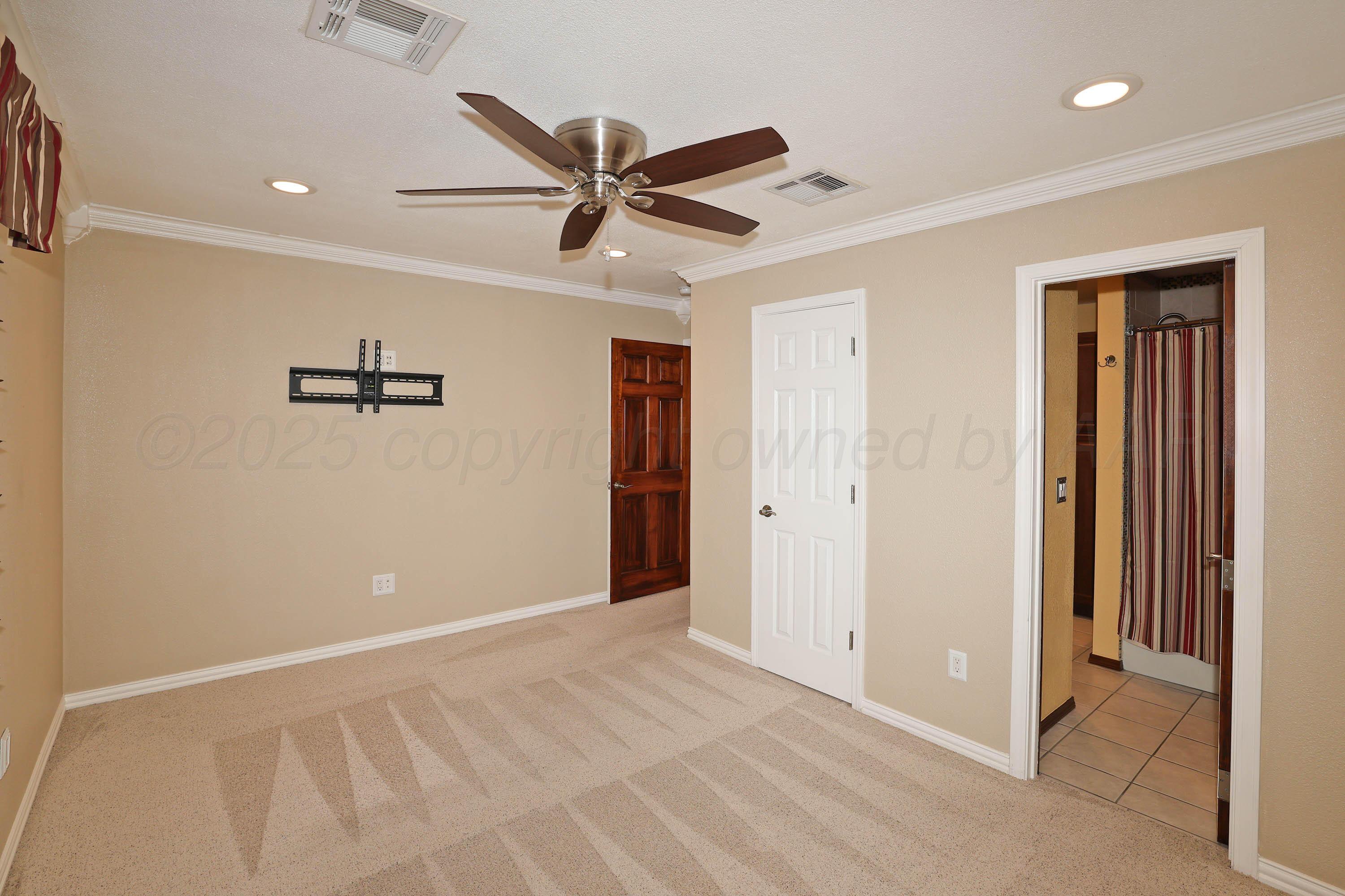 7722 Canode Drive Amarillo, TX 79121 - Photo 24 of 40 a view of a livingroom with a ceiling fan and hardwood floor