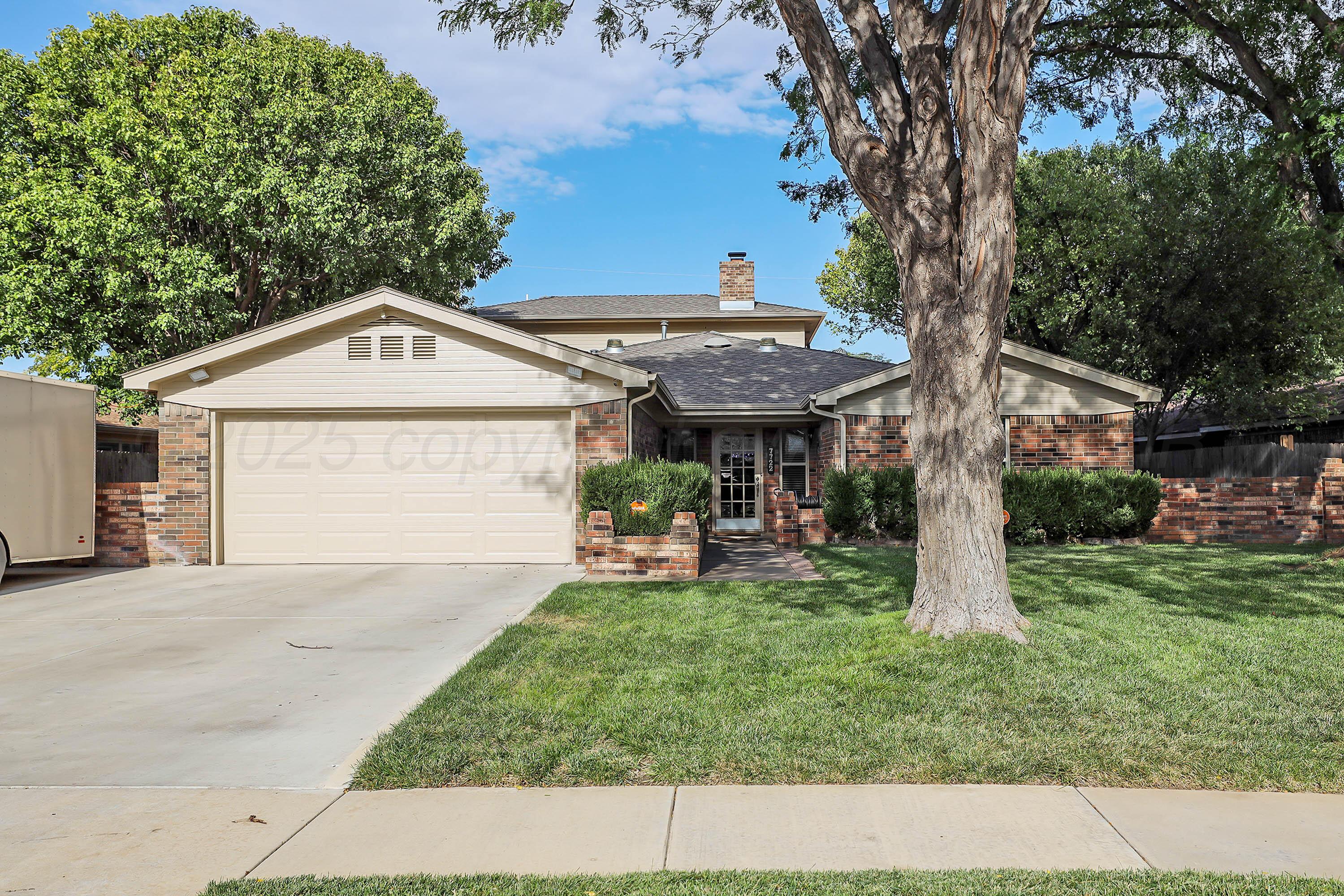 7722 Canode Drive Amarillo, TX 79121 - Photo 40 of 40 a front view of a house with a garden and trees